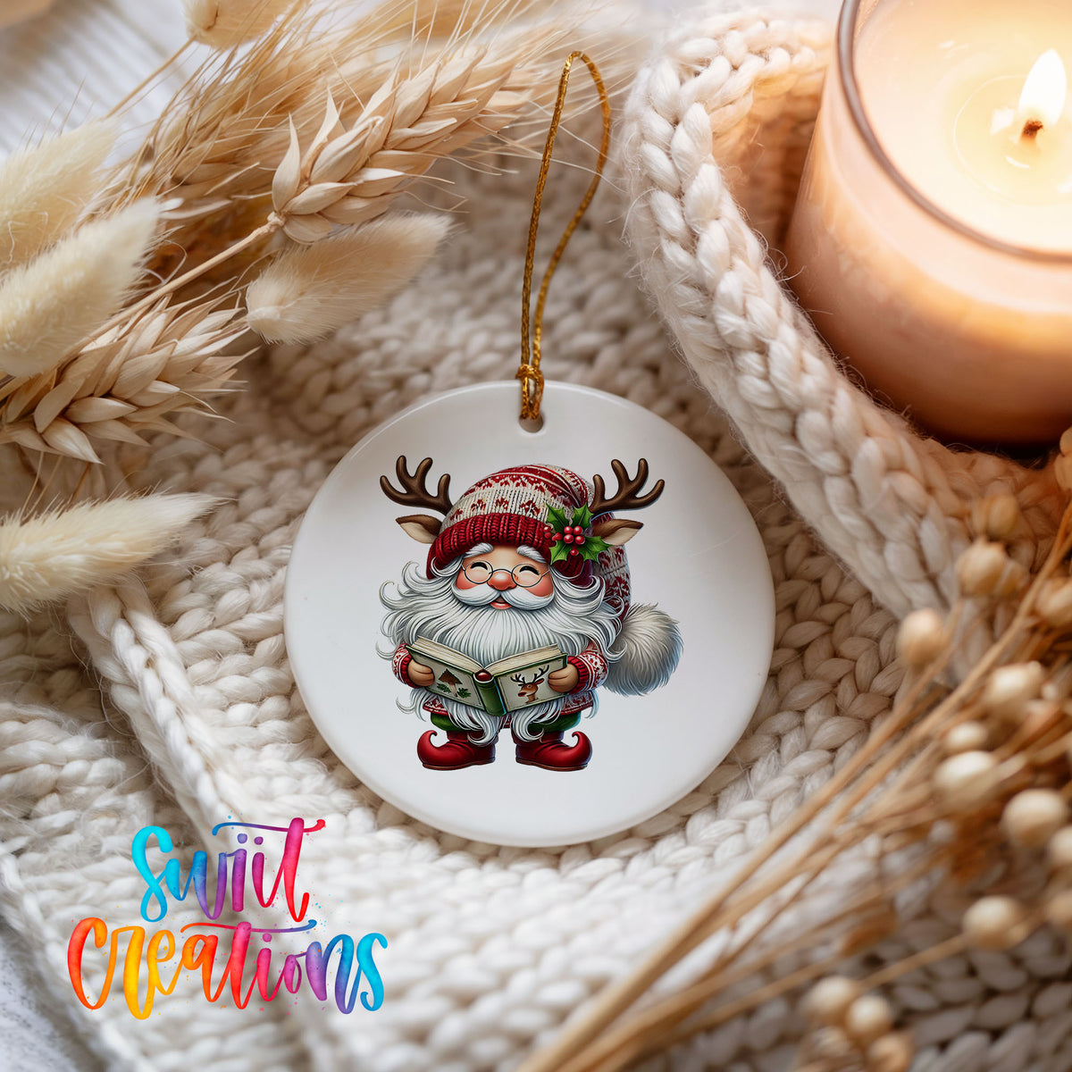 Santa reading a Christmas story ceramic ornament styled beside a candle and cozy knit blanket
