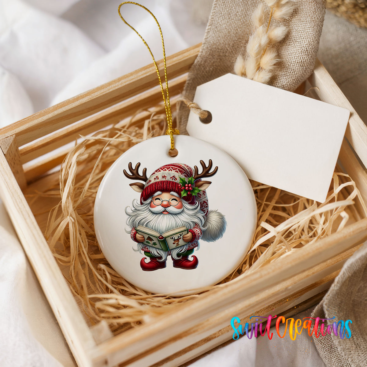 Santa reading a Christmas story ceramic ornament displayed in a rustic wooden gift crate