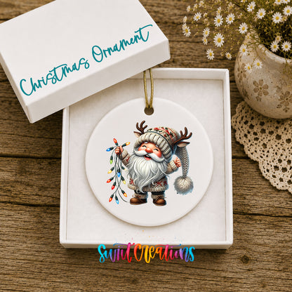 Santa holding colorful Christmas lights ceramic ornament displayed in the included gift box