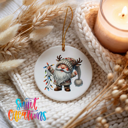 Santa holding colorful Christmas lights ceramic ornament styled beside a candle and cozy knit blanket