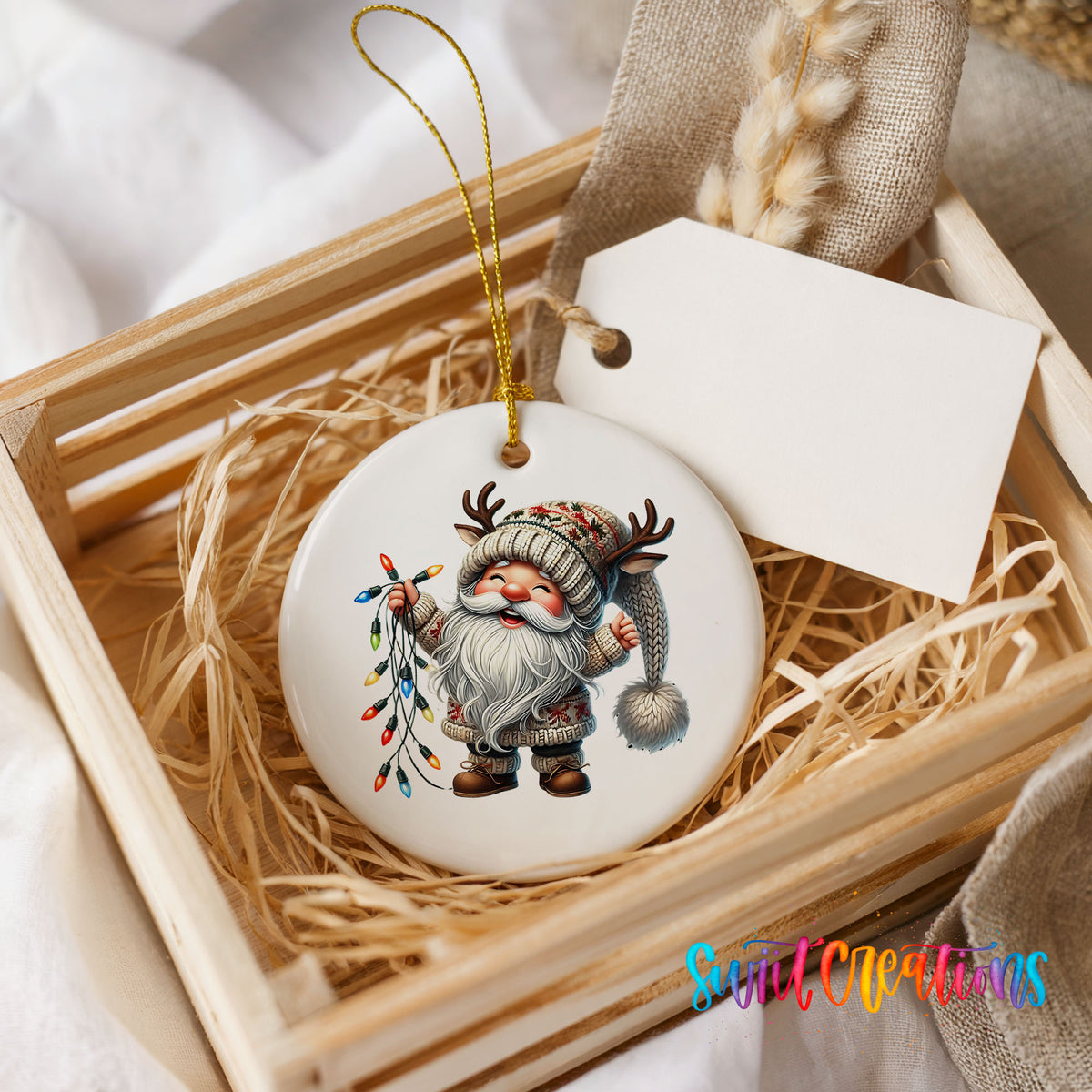 Santa holding colorful Christmas lights ceramic ornament displayed in a rustic wooden gift crate