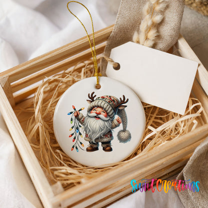 Santa holding colorful Christmas lights ceramic ornament displayed in a rustic wooden gift crate