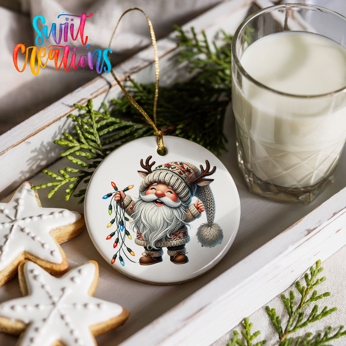 Santa holding colorful Christmas lights ceramic ornament styled with cookies and milk