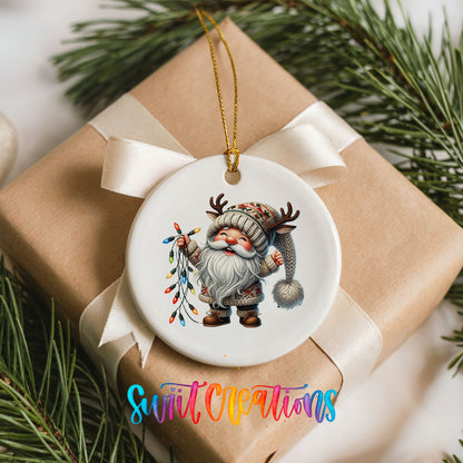 Santa holding colorful Christmas lights ceramic ornament arranged on a wrapped Christmas gift