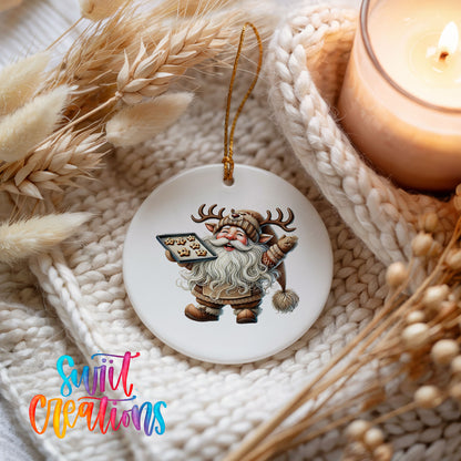 Santa checking his Christmas list ceramic Christmas ornament styled beside a candle and cozy knit blanket