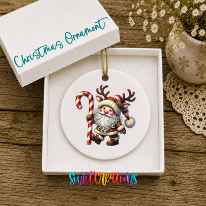 Santa holding an oversized candy cane ceramic Christmas ornament displayed in the included gift box
