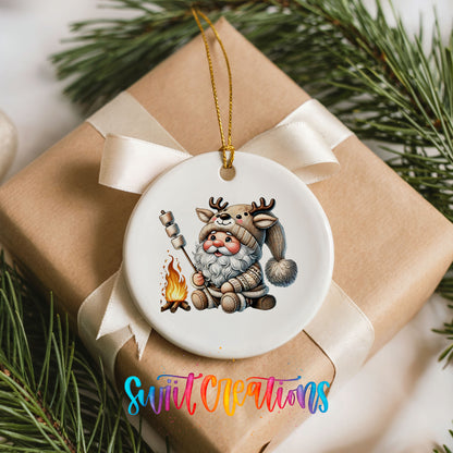 Santa roasting a marshmallow by a campfire ceramic Christmas ornament arranged on a wrapped Christmas gift