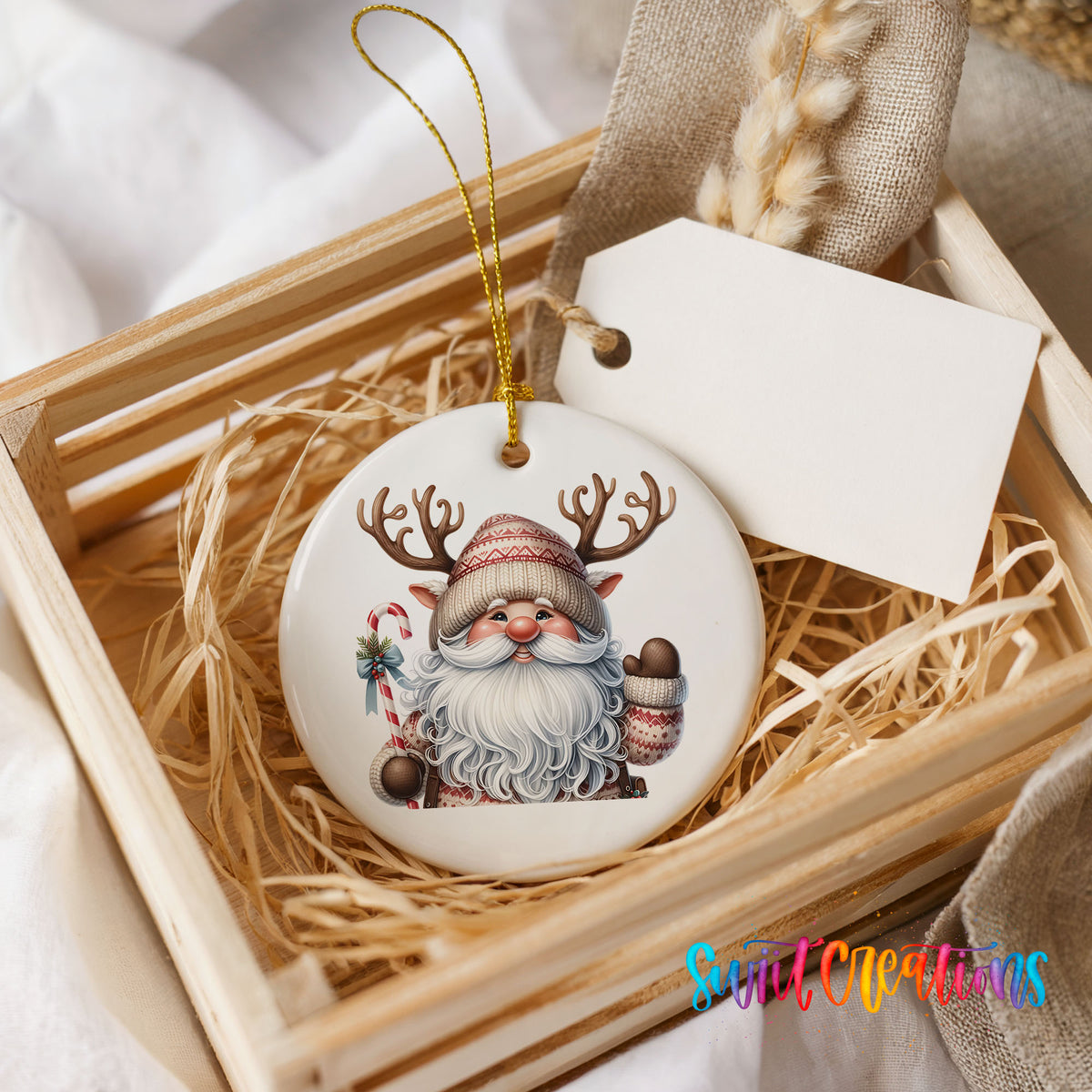 Round ceramic Christmas ornament featuring Santa holding a candy cane and mug of cocoa, presented in a rustic wooden gift crate