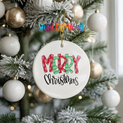 Round ceramic Christmas ornament featuring colorful patterned Merry Christmas typography, hanging on a frosted holiday tree