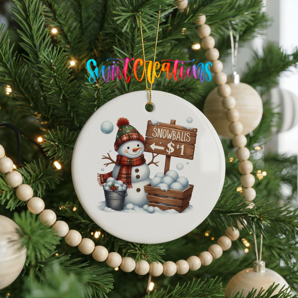 Round ceramic Christmas ornament featuring cheerful snowman selling snowballs for five cents, hanging on a decorated Christmas tree