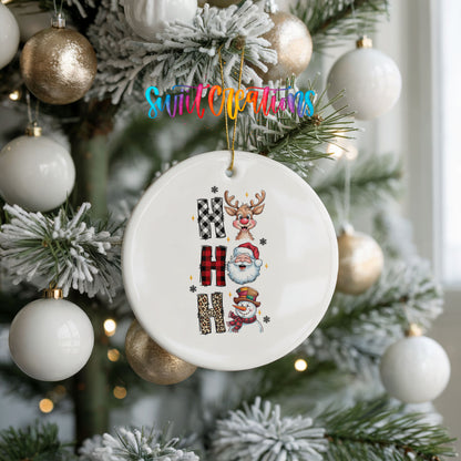 Round ceramic Christmas ornament featuring stacked Ho Ho Ho lettering with cheerful holiday characters, hanging on a frosted holiday tree