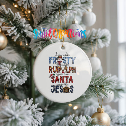 Round ceramic Christmas ornament featuring Dance like Frosty ride like Rudolph give like Santa love like Jesus message, hanging on a frosted Christmas tree