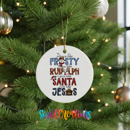 Round ceramic Christmas ornament featuring Dance like Frosty ride like Rudolph give like Santa love like Jesus message, hanging on a green Christmas tree