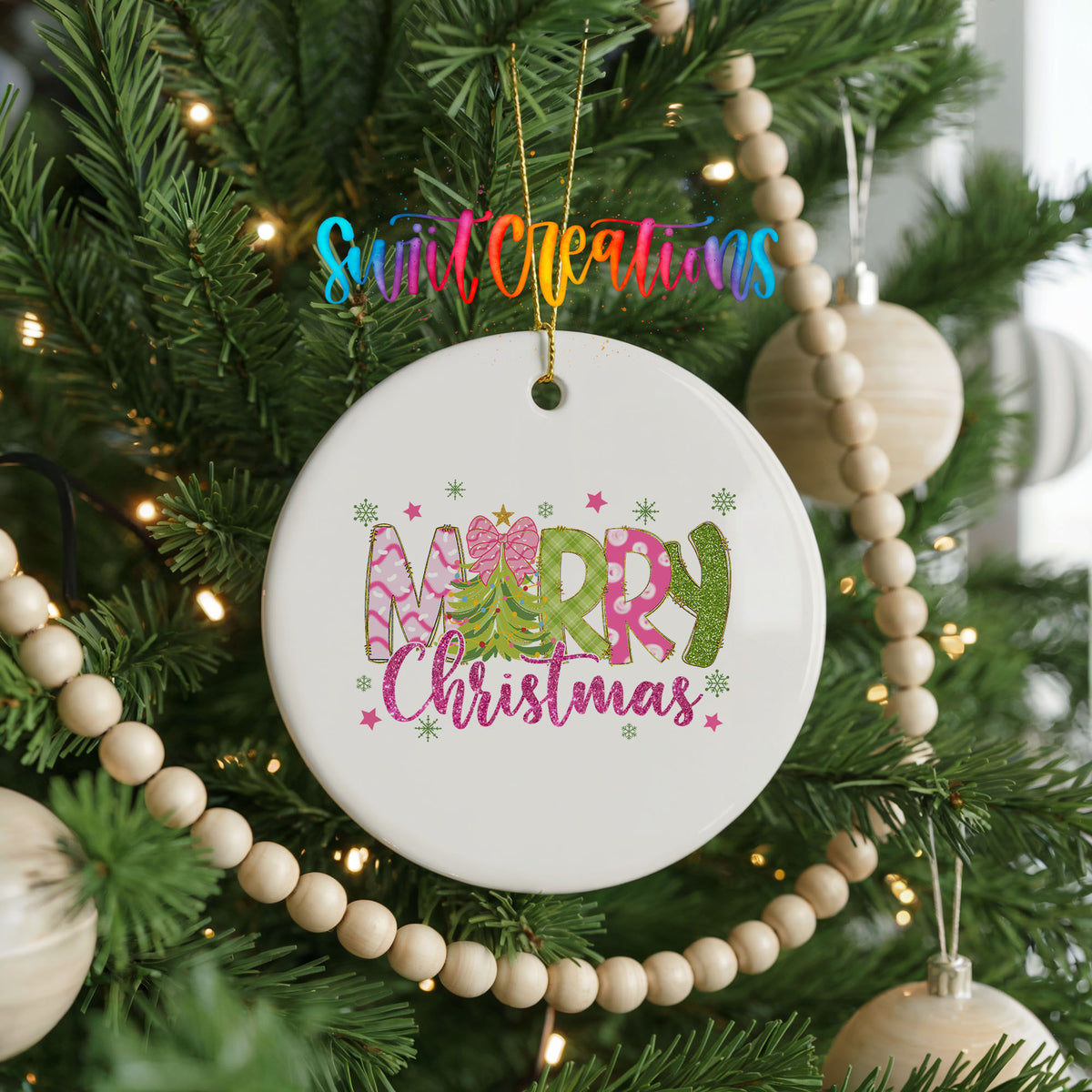 Round ceramic Christmas ornament featuring bright Merry Christmas lettering with candy stripe and floral details, hanging on a decorated Christmas tree