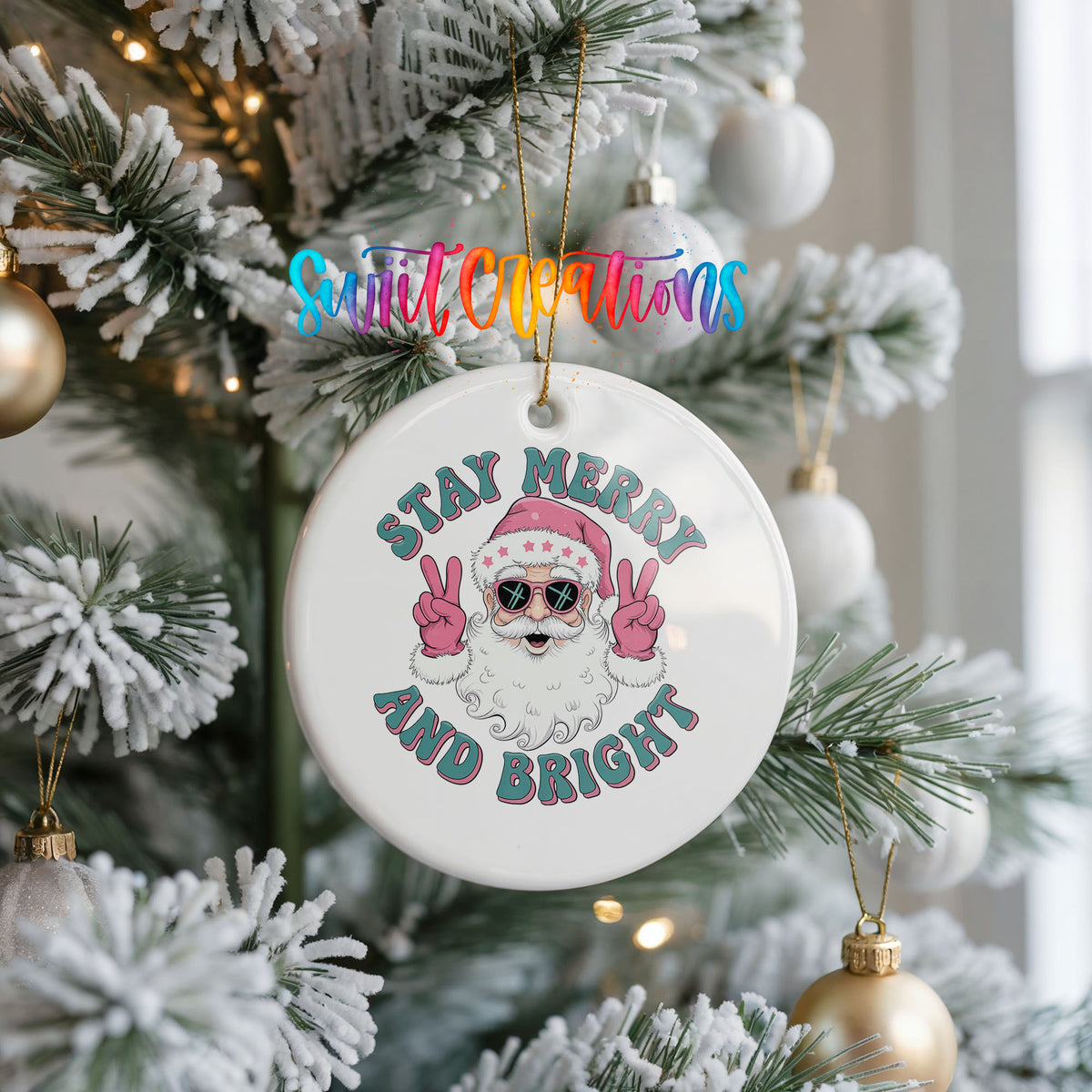Round ceramic Christmas ornament featuring Santa in sunglasses giving peace signs with Stay Merry and Bright lettering, hanging on a frosted Christmas tree