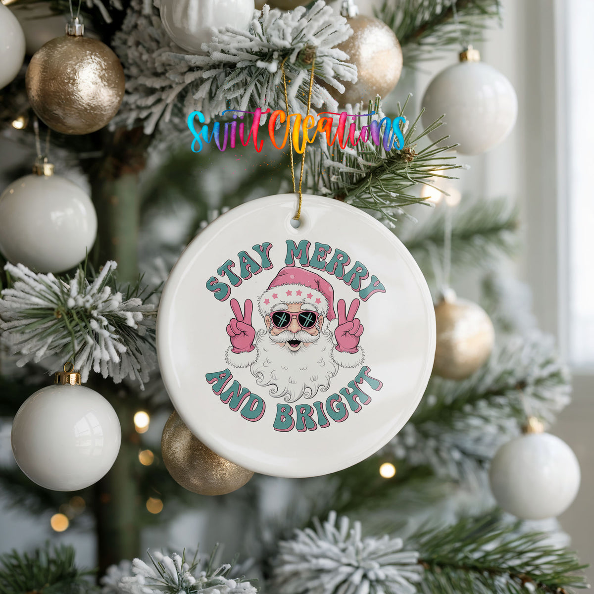 Round ceramic Christmas ornament featuring Santa in sunglasses giving peace signs with Stay Merry and Bright lettering, hanging on a frosted holiday tree