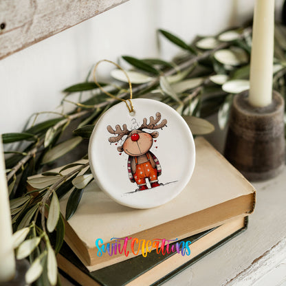 Cute Reindeer in Orange Sweater Christmas ornament styled on books with holiday greenery