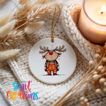 Cute Reindeer in Orange Sweater Christmas ornament styled beside a candle and cozy knit blanket
