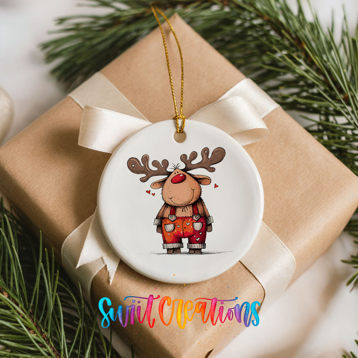 Reindeer in Red Plaid Overalls Christmas ornament placed on a wrapped Christmas gift
