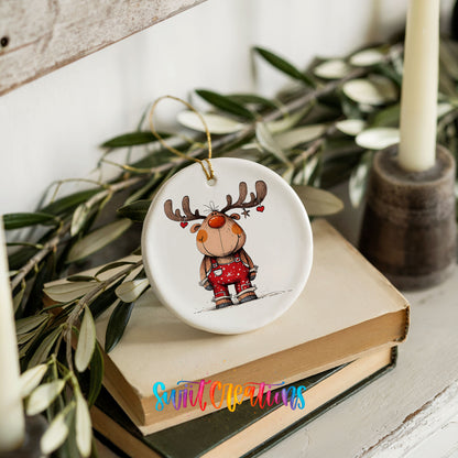 Reindeer in Red Plaid Sweater Christmas ornament styled on books with holiday greenery