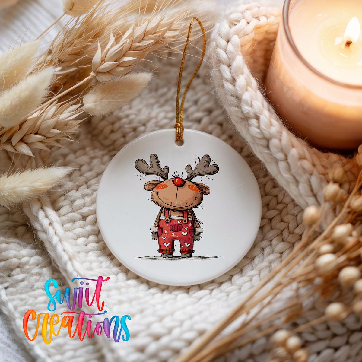 Reindeer in Red Plaid Outfit Christmas ornament styled beside a candle and cozy knit blanket
