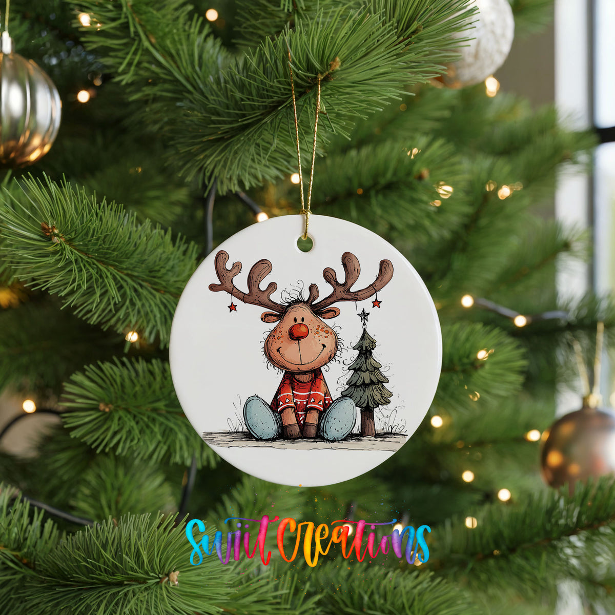 Sitting Reindeer with Gift and Christmas Tree Christmas ornament hanging on a green Christmas tree