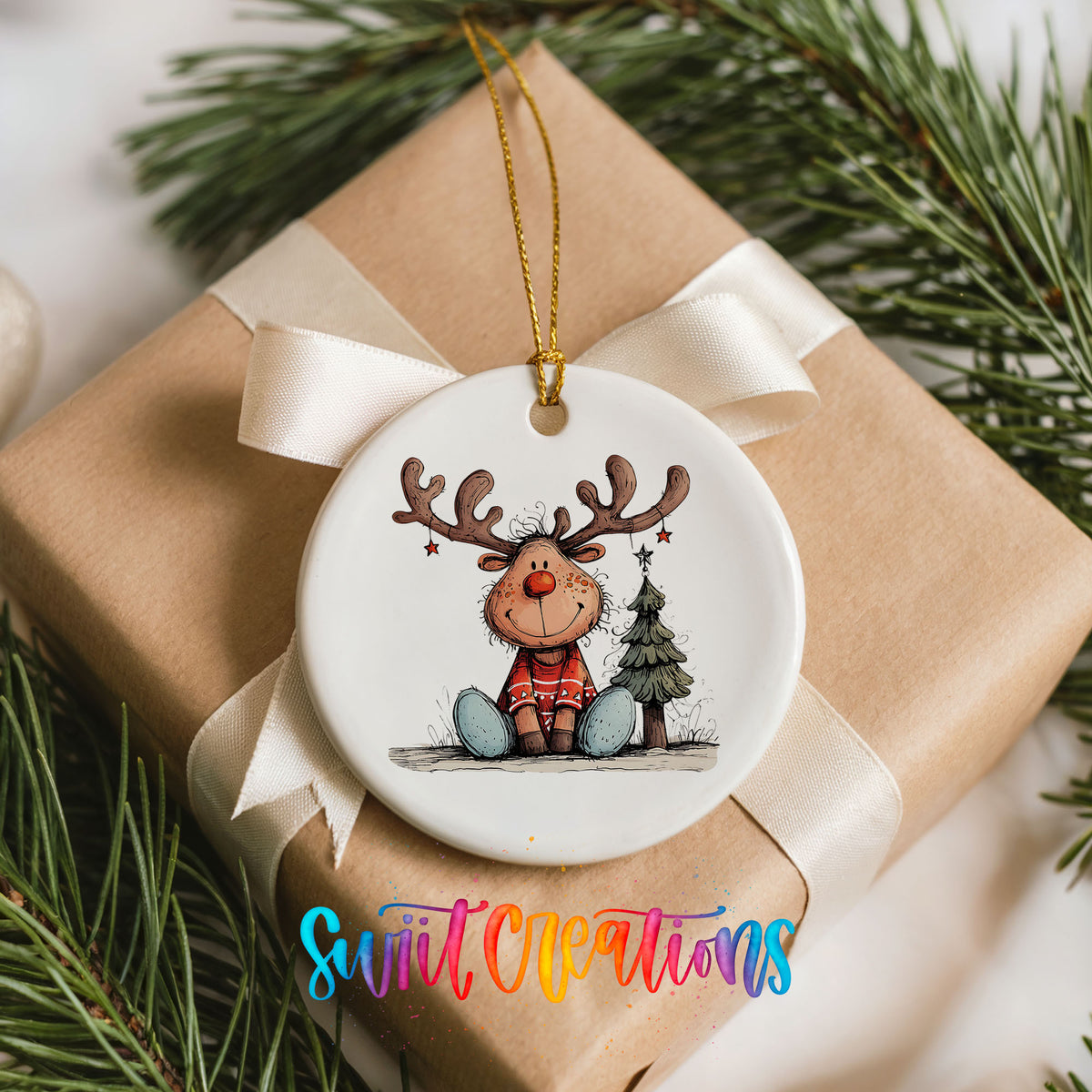 Sitting Reindeer with Gift and Christmas Tree Christmas ornament placed on a wrapped Christmas gift