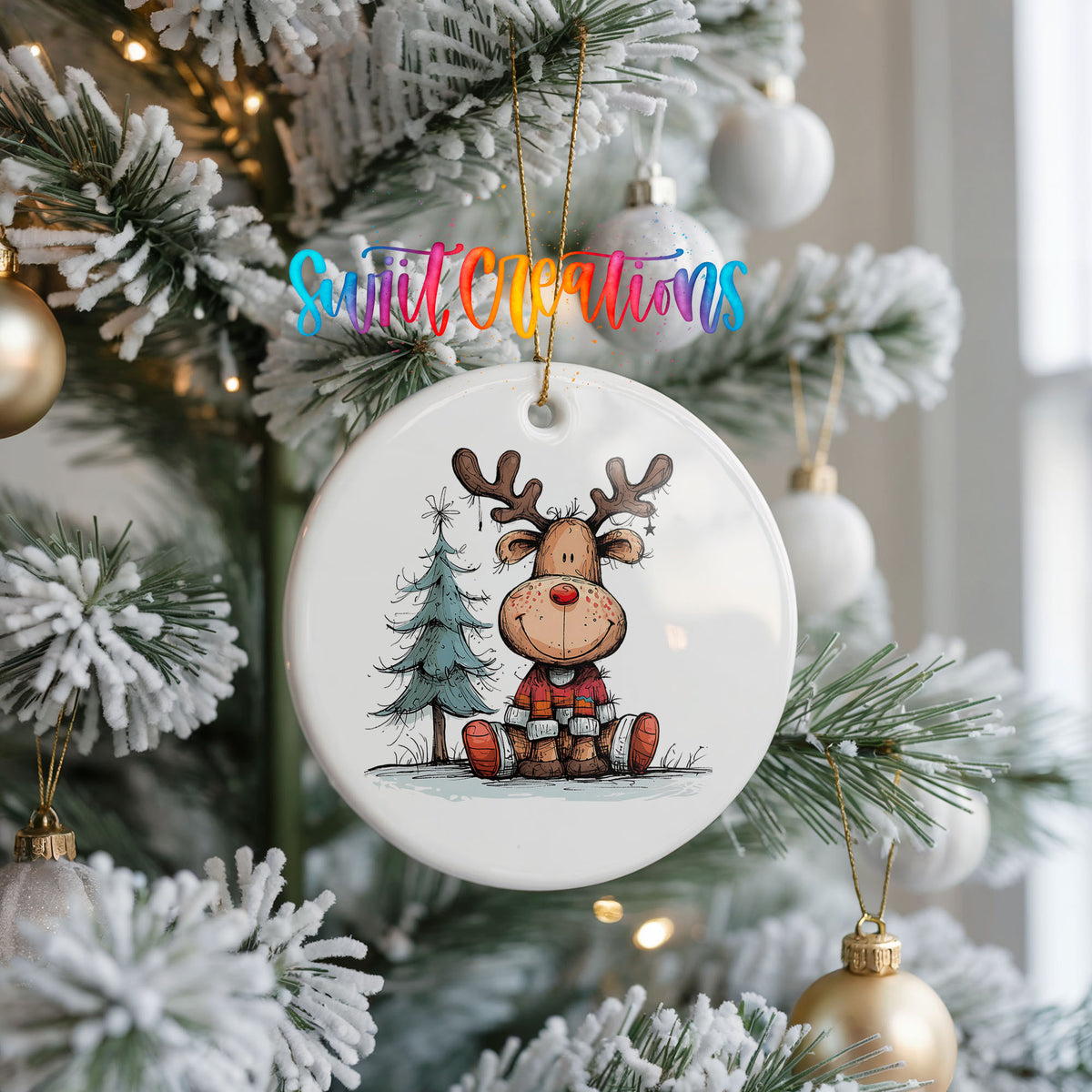 Sitting Reindeer with Pine Trees and Gift Christmas ornament hanging on a frosted Christmas tree