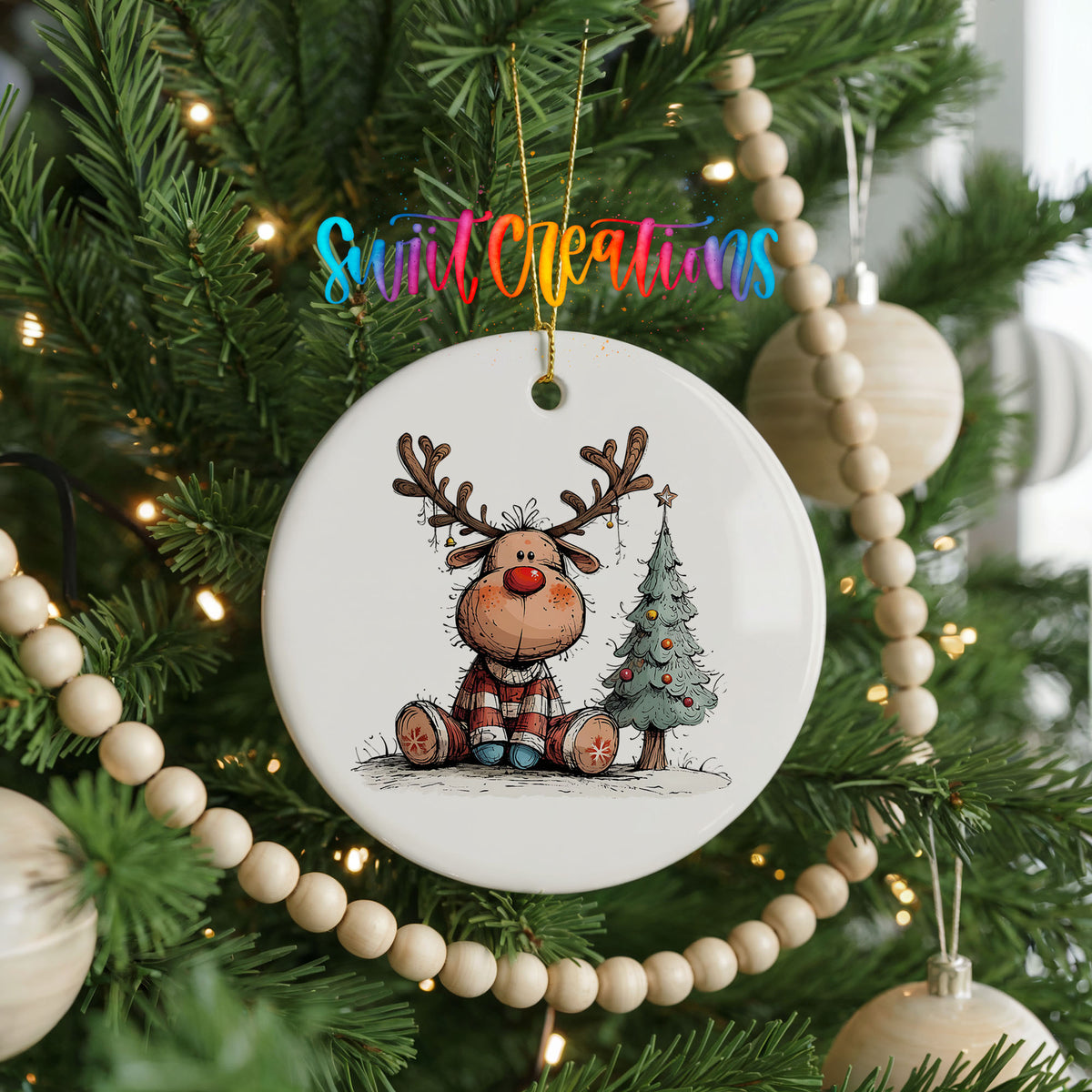Sitting Reindeer Beside Christmas Tree Christmas ornament hanging on a decorated Christmas tree