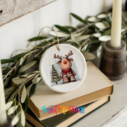 Reindeer in Red Scarf with Pine Trees Christmas ornament styled on books with holiday greenery
