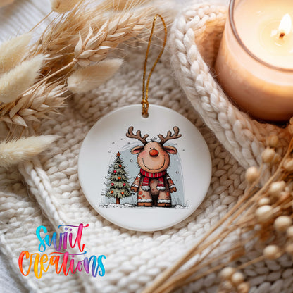 Reindeer in Red Scarf with Pine Trees Christmas ornament styled beside a candle and cozy knit blanket