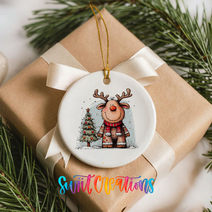 Reindeer in Red Scarf with Pine Trees Christmas ornament placed on a wrapped Christmas gift