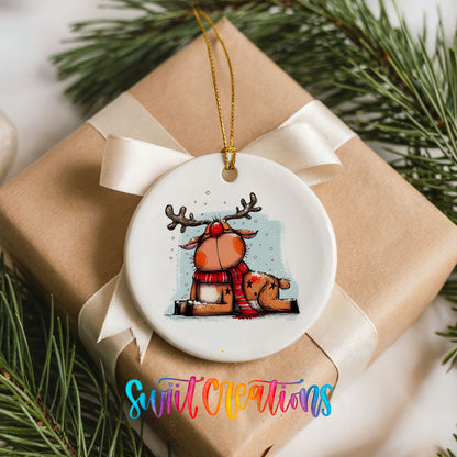 Santa and Reindeer with Gift Sack Christmas ornament placed on a wrapped Christmas gift