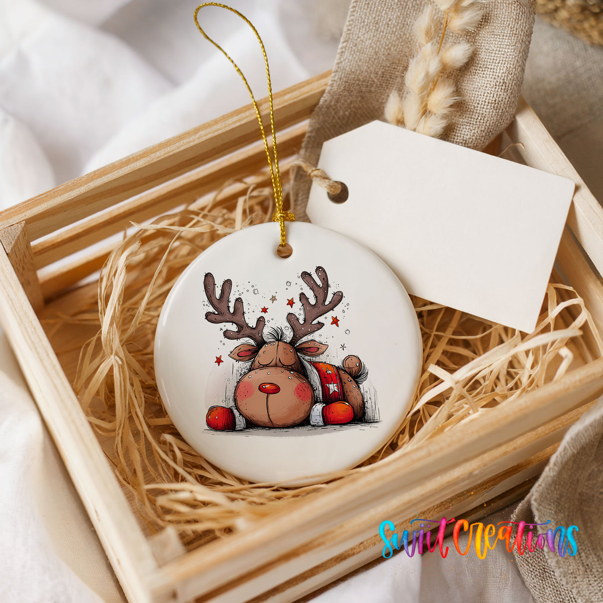Cute Reindeer with Red Gift Bag Christmas ornament presented in a rustic wooden gift crate