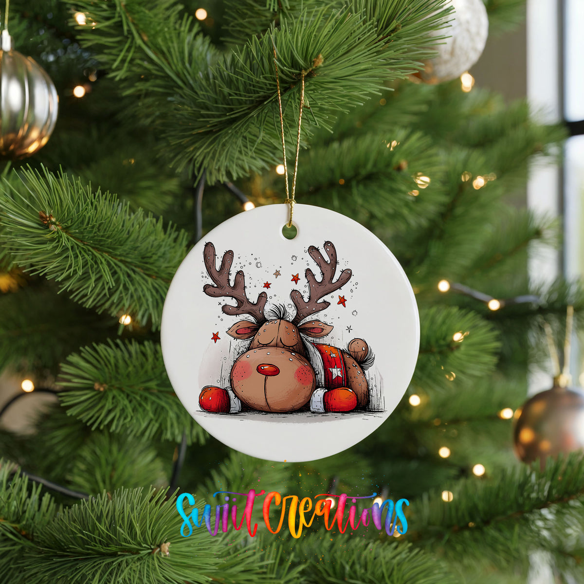 Cute Reindeer with Red Gift Bag Christmas ornament hanging on a green Christmas tree