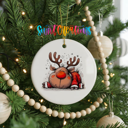 Sleeping Reindeer in Red Scarf Christmas ornament hanging on a decorated Christmas tree