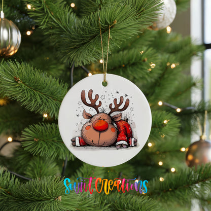 Sleeping Reindeer in Red Scarf Christmas ornament hanging on a green Christmas tree