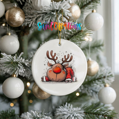 Sleeping Reindeer in Red Scarf Christmas ornament hanging on a frosted holiday tree