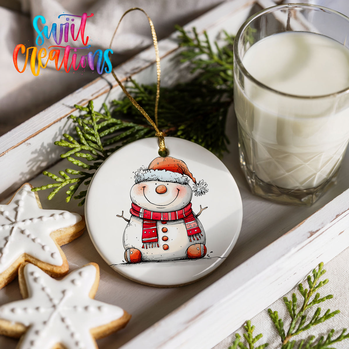 Cheerful Snowman in Santa Hat Christmas ornament styled with cookies and milk