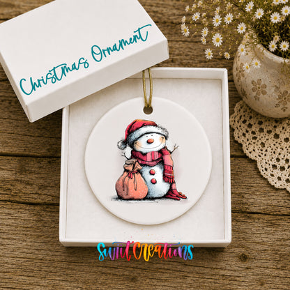 Snowman with Pink Gift Sack Christmas ornament displayed in an included gift box