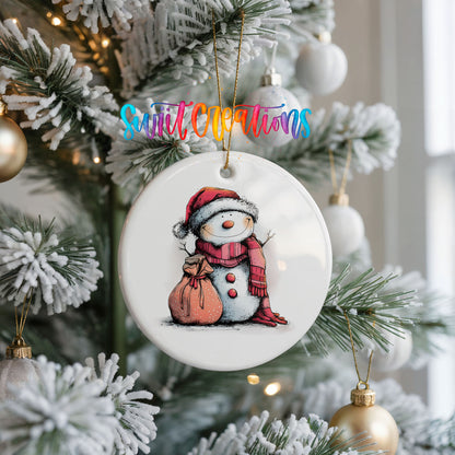 Snowman with Pink Gift Sack Christmas ornament hanging on a frosted Christmas tree
