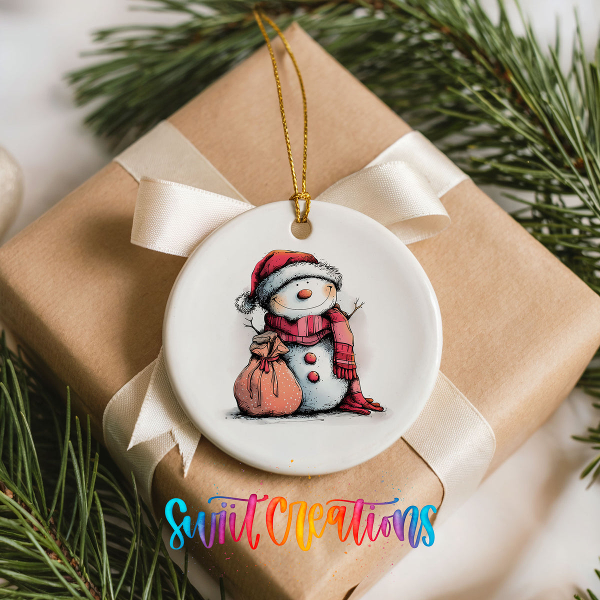 Snowman with Pink Gift Sack Christmas ornament placed on a wrapped Christmas gift