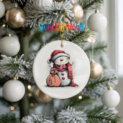 Snowman with Pink Gift Sack Christmas ornament hanging on a frosted holiday tree
