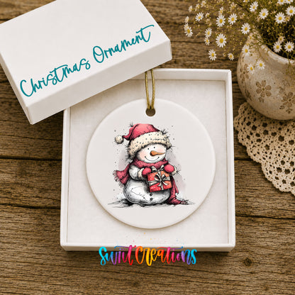 Snowman Holding a Christmas Heart Christmas ornament displayed in an included gift box