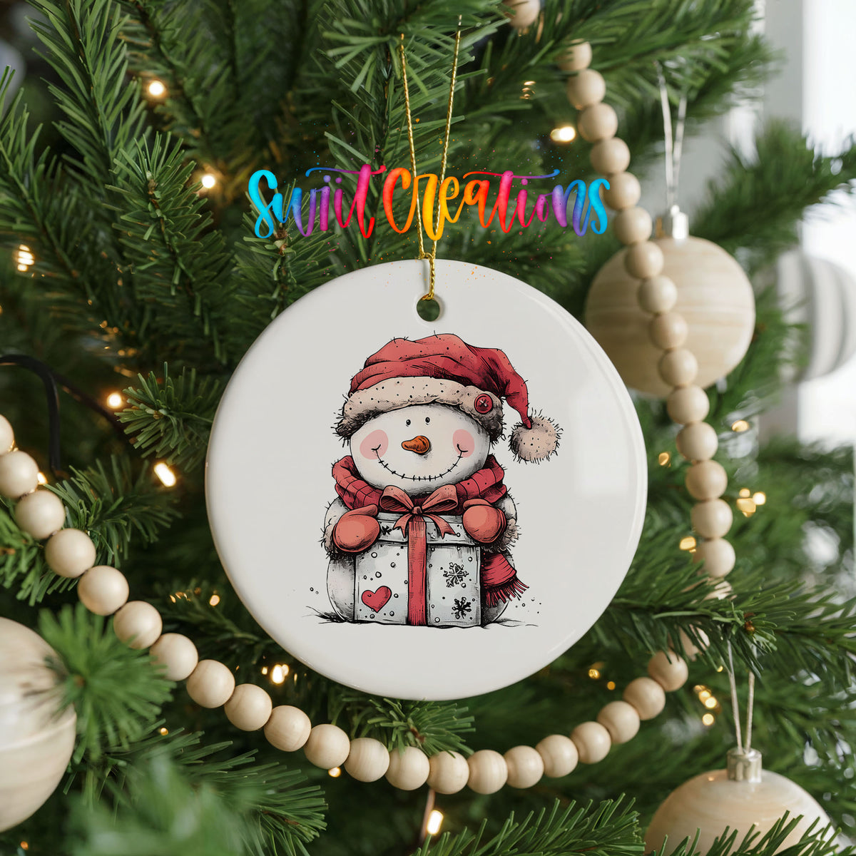 Snowman with Wrapped Christmas Gift Christmas ornament hanging on a decorated Christmas tree