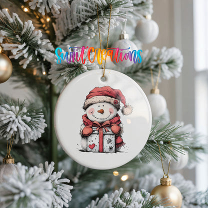 Snowman with Wrapped Christmas Gift Christmas ornament hanging on a frosted Christmas tree