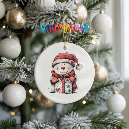 Snowman with Wrapped Christmas Gift Christmas ornament hanging on a frosted holiday tree
