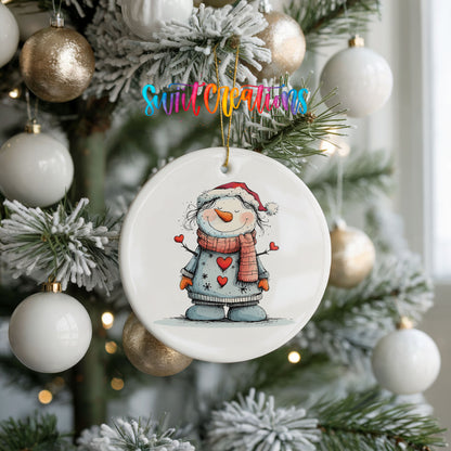 Snowman in Gray Coat and Red Scarf Christmas ornament hanging on a frosted holiday tree