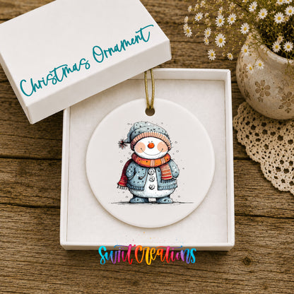 Smiling Snowman in Blue Winter Hat Christmas ornament displayed in an included gift box