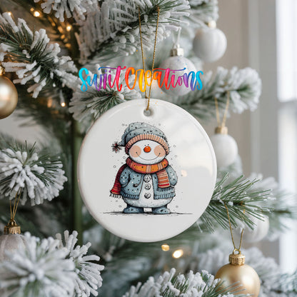 Smiling Snowman in Blue Winter Hat Christmas ornament hanging on a frosted Christmas tree